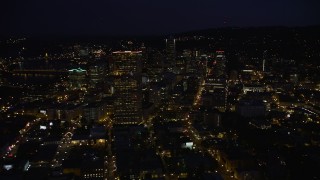 AX55_027E - 5K aerial stock footage fly over downtown to approach KOIN Center and Wells Fargo Center, Downtown Portland, Oregon, night