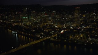 AX55_038 - 5K stock footage aerial video of following Burnside Street Bridge, approaching Downtown Portland, Oregon, night