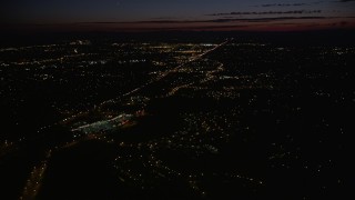 AX55_062E - 5K aerial stock footage of flying over suburbs to approach Highway 26 in Southwest Portland, Oregon, night