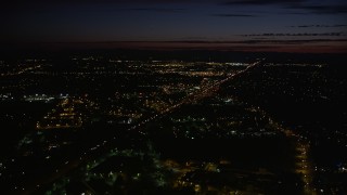 AX55_065E - 5K aerial stock footage of flying over Highway 26 and shopping center, Beaverton, Oregon, night
