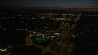 AX55_066 - 5K aerial stock footage of flying over Highway 26 and shopping center, Beaverton, Oregon, night
