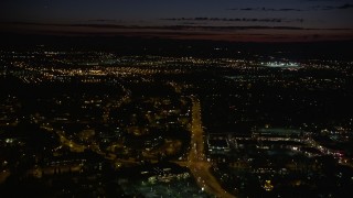AX55_068 - 5K aerial stock footage of approaching office buildings and wide streets, Beaverton, Oregon, night