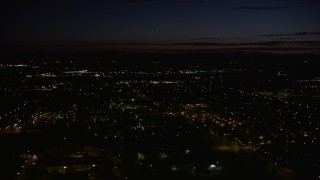 AX55_070E - 5K aerial stock footage of flying over dark office building by neighborhood in Hillsboro, Oregon, night