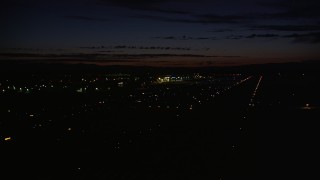 AX55_073 - 5K aerial stock footage of flying by Hillsboro Airport, Hillsboro, Oregon, night