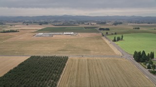 AX56_003 - 5K aerial stock footage of farm fields, greenhouses, and country roads in Hillsboro, Oregon