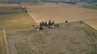 AX56_005 - 5K aerial stock footage approach a farmhouse beside a country road in Hillsboro, Oregon