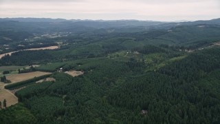 AX56_016 - 5K aerial stock footage approach small farms beside evergreen forest in Washington County, Oregon