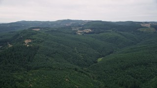 AX56_017 - 5K aerial stock footage of a view of evergreen forest and a few logging areas in Washington County, Oregon