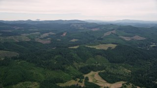 AX56_020E - 5K aerial stock footage of flying over evergreen forest and clear cuts areas in Washington County, Oregon