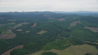 AX56_022 - 5K aerial stock footage of wide expanse of evergreen forest and clear cut areas in Washington County, Oregon