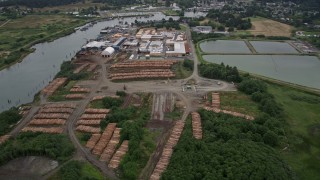 AX56_074 - 5K aerial stock footage of Skipanon River and a lumber mill in Warrenton, Oregon