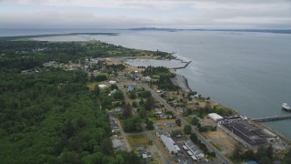 AX56_077 - 5K aerial stock footage fly over riverfront homes to approach Hammond Marine in Warrenton, Oregon
