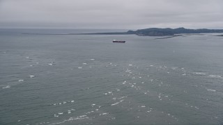 AX56_083 - 5K aerial stock footage fly over Columbia River, approach oil tanker near Cape Disappointment, Washington
