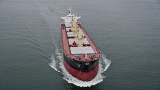 AX56_086 - 5K aerial stock footage of tracking an oil tanker sailing on the Columbia River near Cape Disappointment, Washington