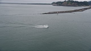 AX56_087 - 5K aerial stock footage approach and track a fishing boat sailing on the Columbia River near Cape Disappointment, Washington