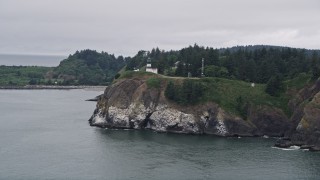 AX56_088 - 5K aerial stock footage approach Cape Disappointment Light on cliffs in Washington