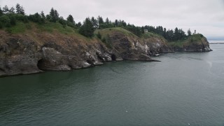 AX56_092E - 5K aerial stock footage of tracking the Cape Disappointment Light atop coastal cliffs, Washington