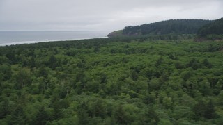 AX56_102 - 5K aerial stock footage of North Head Light seen from Cape Disappointment State Park, Ilwaco, Washington