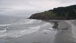 AX56_106E - 5K aerial stock footage approach and track the North Head Light on top of an oceanside cliff, Ilwaco, Washington