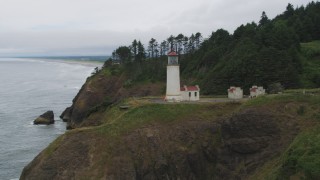 AX56_107 - 5K aerial stock footage approach the North Head Light on top of an oceanside cliff, Ilwaco, Washington