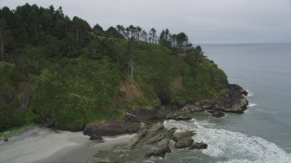 AX56_109 - 5K stock footage aerial video approach rugged green cliffs in Ilwaco, Washington