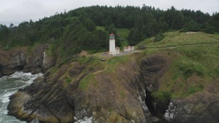 AX56_117 - 5K aerial stock footage of an orbit of the North Head Light, on a cliff overlooking the ocean in Ilwaco, Washington