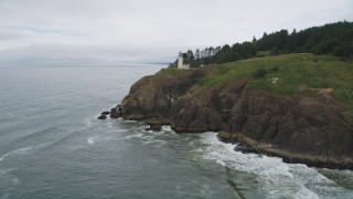 AX56_118 - 5K aerial stock footage approach the North Head Light on a steep cliff in Ilwaco, Washington