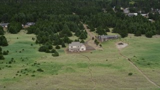 AX56_144 - 5K aerial stock footage of rural homes with trees, green fields in Oceanside, Washington