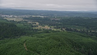AX56_171 - 5K aerial stock footage of approaching small farms from evergreen forest in Raymond, Washington
