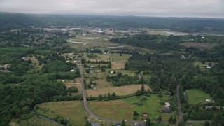 AX56_173 - 5K aerial stock footage of small farms around Fowler Road by the Willapa River near the small town of Raymond, Washington