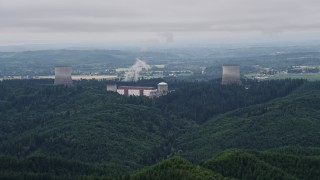 AX57_007E - 5K aerial stock footage of Satsop Nuclear Power Plant cooling towers surrounded by forest, Satsop, Washington