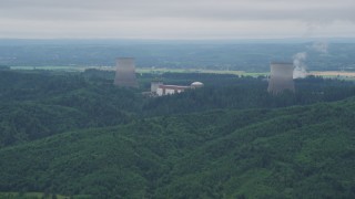 AX57_009 - 5K aerial stock footage of Satsop Nuclear Power Plant cooling towers surrounded by forest, Satsop, Washington