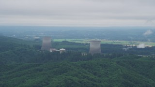 AX57_010 - 5K aerial stock footage of Satsop Nuclear Power Plant, farmland in the background, Washington