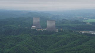 AX57_012 - 5K aerial stock footage of a pair of cooling towers at the Satsop Nuclear Power Plant, Satsop, Washington