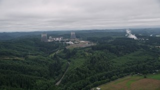 AX57_015 - 5K aerial stock footage of Satsop Nuclear Power Plant surrounded by forest in Satsop, Washington