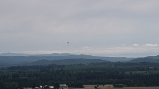 AX57_038 - 5K aerial stock footage track a skydiver landing at Sanderson Field airport, Shelton, Washington