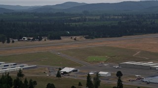 AX57_039 - 5K aerial stock footage of skydiver coming in for a landing at Sanderson Field airport, Shelton, Washington