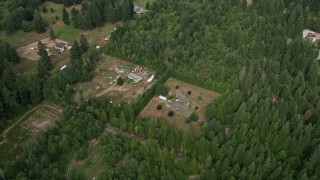 AX58_013 - 5K aerial stock footage tilt to a bird's eye view of rural homes and evergreen trees in Grapeview, Washington