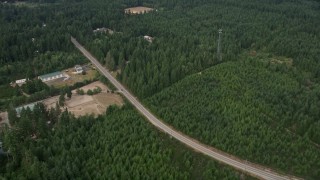 AX58_014 - 5K aerial stock footage of rural homes and buildings beside Mason Benson Road, Grapeview, Washington