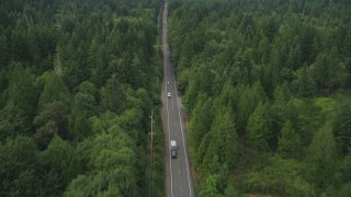 AX58_032 - 5K stock footage aerial video of Wright Bliss Road through evergreen forest in Gig Harbor, Washington