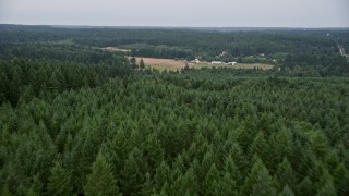 AX58_038E - 5K aerial stock footage fly over the fields of a small farm in Gig Harbor, Washington