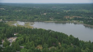 AX58_045 - 5K aerial stock footage tilt from rural homes to approach marsh in Burley Lagoon, Gig Harbor, Washington