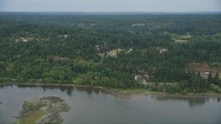 AX58_046 - 5K aerial stock footage fly over Burley Lagoon to approach rural homes in Olalla, Washington