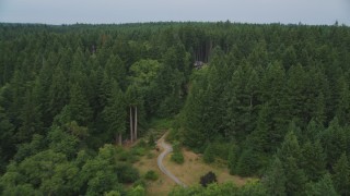 AX58_055 - 5K aerial stock footage approach an isolated home in the woods on Vashon Island, Washington