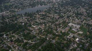 AX58_070 - 5K aerial stock footage fly over and tilt to suburban homes near Lake Burien in Burien, Washington