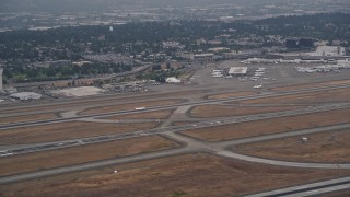 AX58_071 - 5K aerial stock footage track airliner taking off from Seattle Tacoma International Airport, Seattle, Washington
