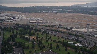 AX58_074 - 5K aerial stock footage of runways and control tower at Seattle Tacoma International Airport, Seattle, Washington