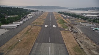 AX58_082E - 5K aerial stock footage fly over the runway and landing at Renton Municipal Airport, Renton, Washington