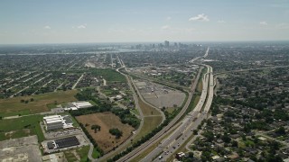AX59_002 - 5K aerial stock footage fly over I-10 through Gentilly to approach Downtown New Orleans, Louisiana skyline