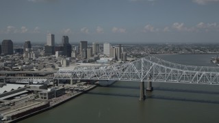 AX59_011 - 5K aerial stock footage of Crescent City Connection Bridge and Downtown New Orleans skyscrapers, Louisiana